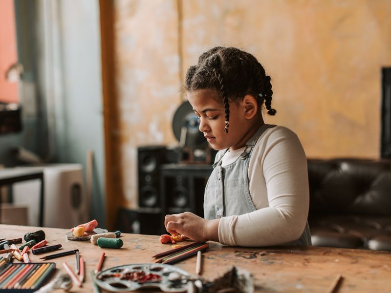 Girl engaged in clay art therapy